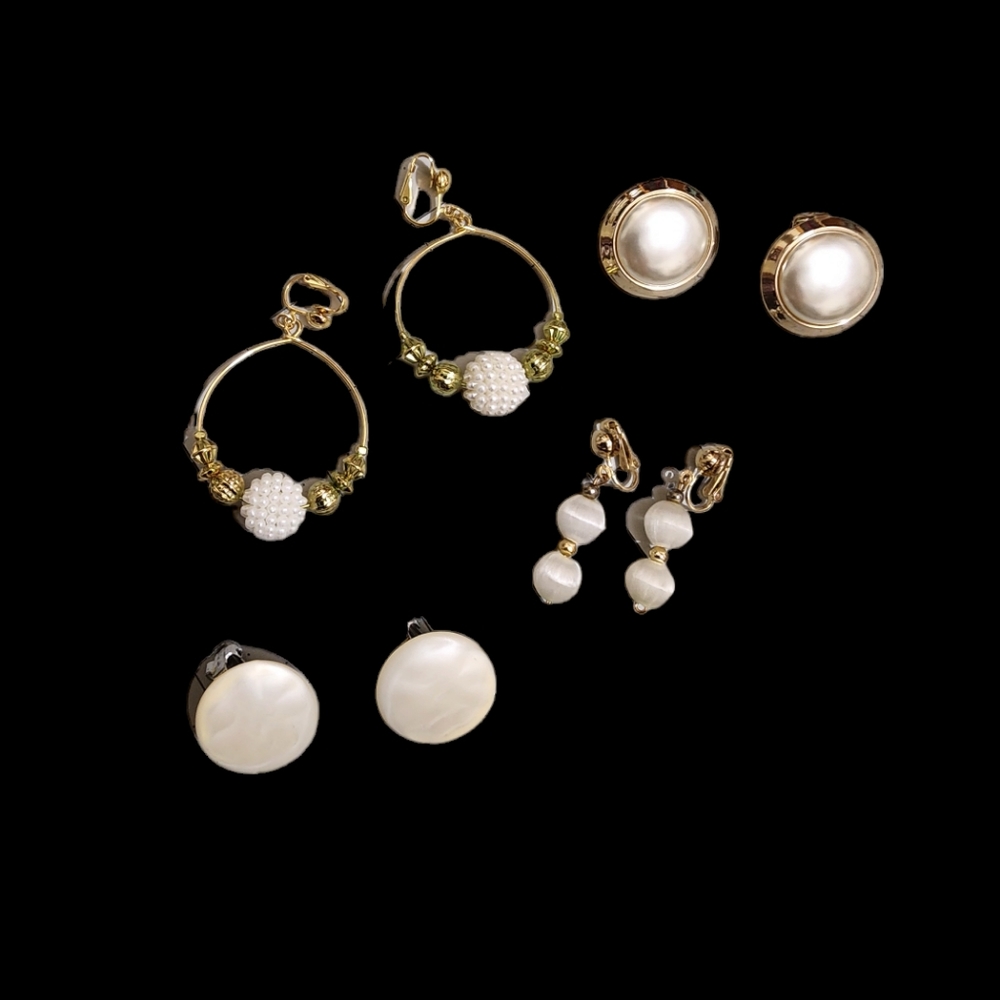 Set of four white vintage clip-on earrings